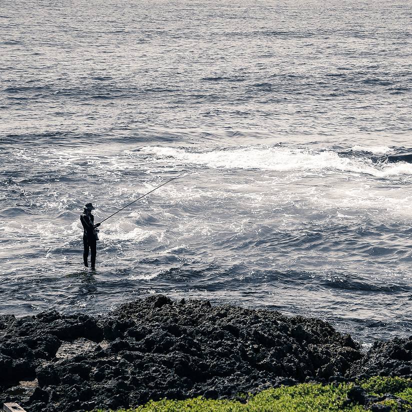 man fishing on the beach