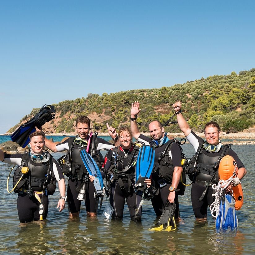 group of divers waving to camera